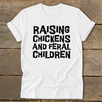 White t-shirt with black text "RAISING CHICKENS AND FERAL CHILDREN".