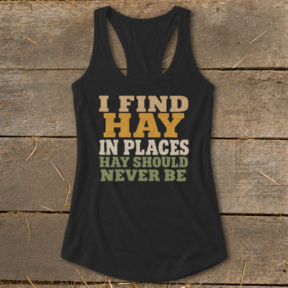 Black tank top with "I FIND HAY IN PLACES HAY SHOULD NEVER BE" text.