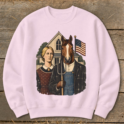 A light pink crewneck sweatshirt featuring a graphic parody of American Gothic with a horse holding a pitchfork.