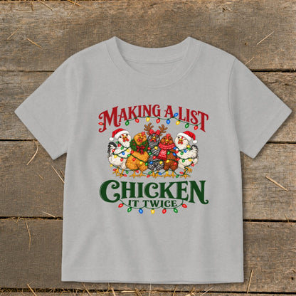 Light gray t-shirt with chickens wearing Santa hats and Christmas lights, reading "Making A List Chicken It Twice".