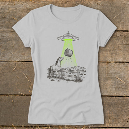 Line drawing of a horse in a pen being abducted by a UFO, taking a bale of hay.