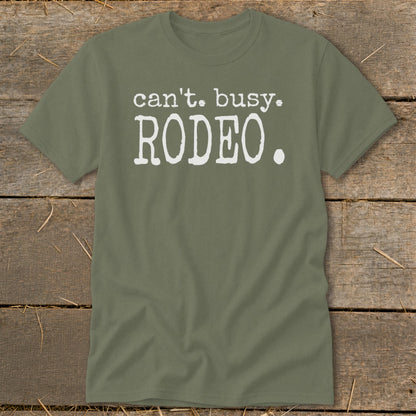Olive green t-shirt with white text that says "can't. busy. RODEO."