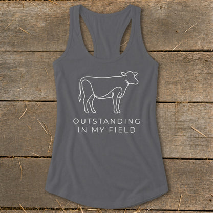 Gray racerback tank with a white line drawing of a cow and the text "OUTSTANDING IN MY FIELD".
