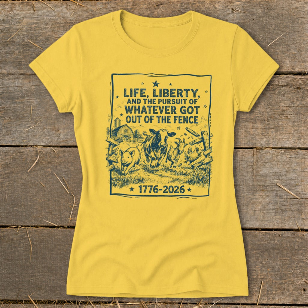 Yellow t-shirt with dark blue graphic of farm animals escaping a fence, text "Life, Liberty, and the Pursuit of Whatever Got Out of the Fence 1776-2026".