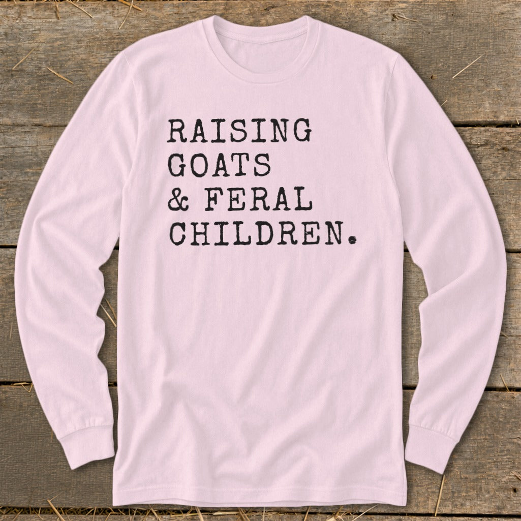 Pink long sleeve shirt with text "RAISING GOATS & FERAL CHILDREN."