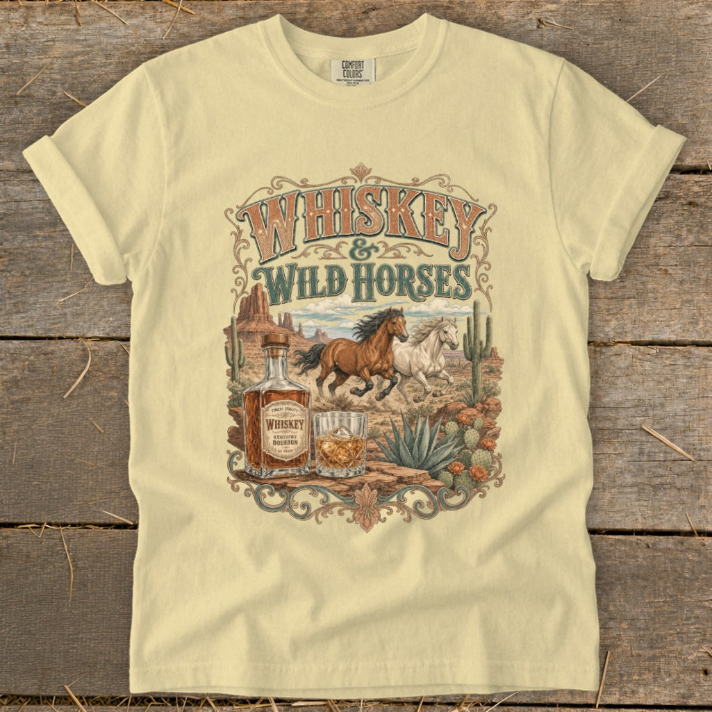 T-shirt graphic: vintage desert scene with horses, whiskey bottle, and cactus.