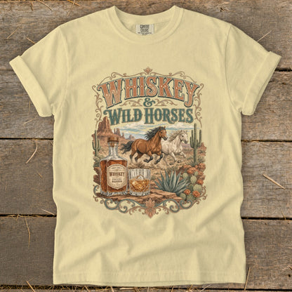 T-shirt graphic: vintage desert scene with horses, whiskey bottle, and cactus.
