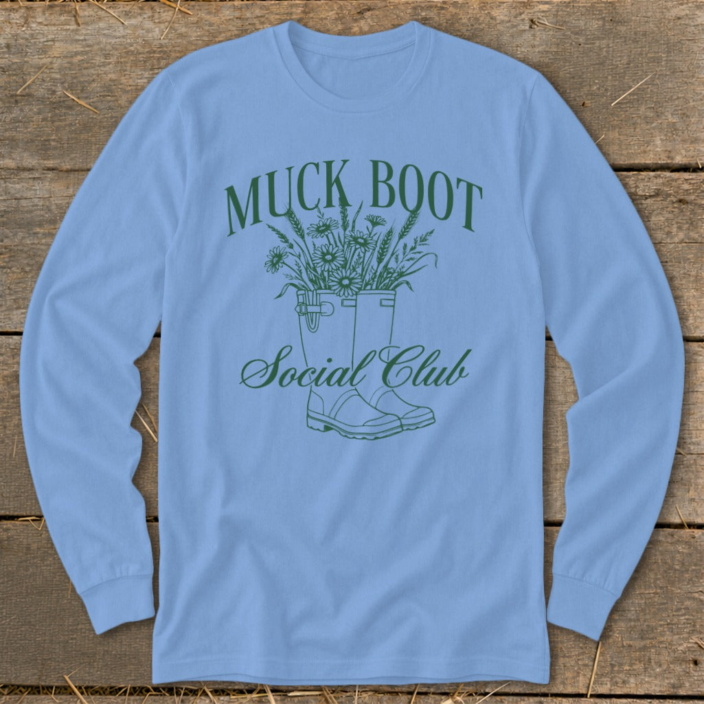 Blue long-sleeve shirt with green "Muck Boot Social Club" text and floral boot design.