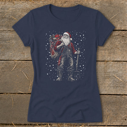 Santa Claus in overalls carrying a sack of gifts and a pitchfork with falling snow.