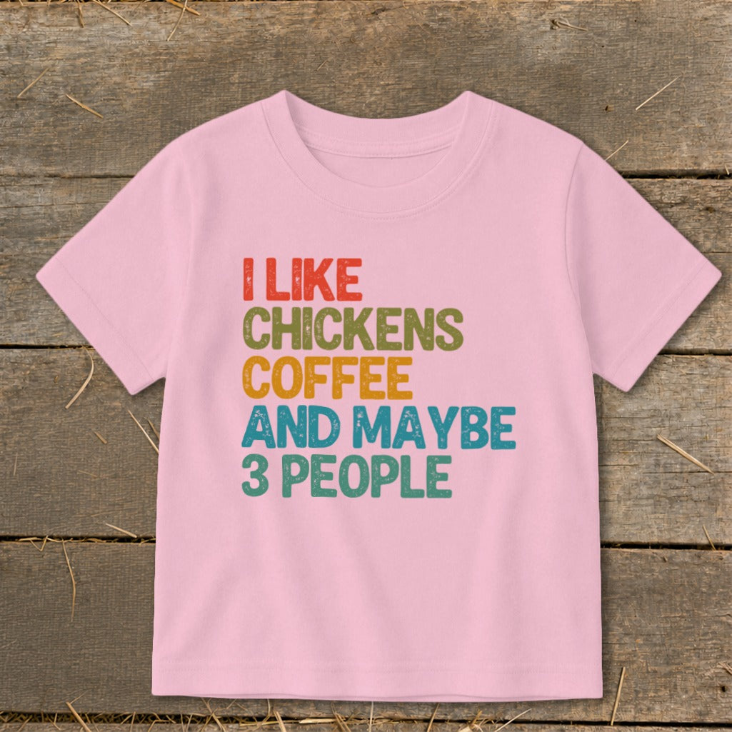 Pink t-shirt with "I like chickens coffee and maybe 3 people" text.