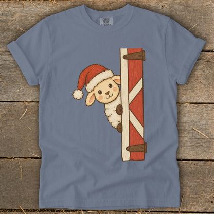 Sheep in Santa hat peeking from behind barn door.