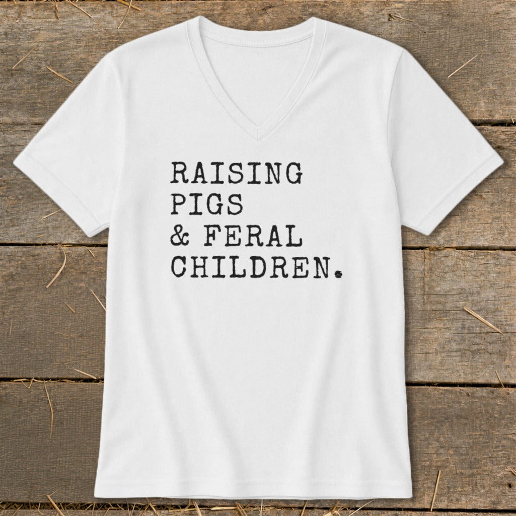 White V-neck t-shirt with black text "RAISING PIGS & FERAL CHILDREN."
