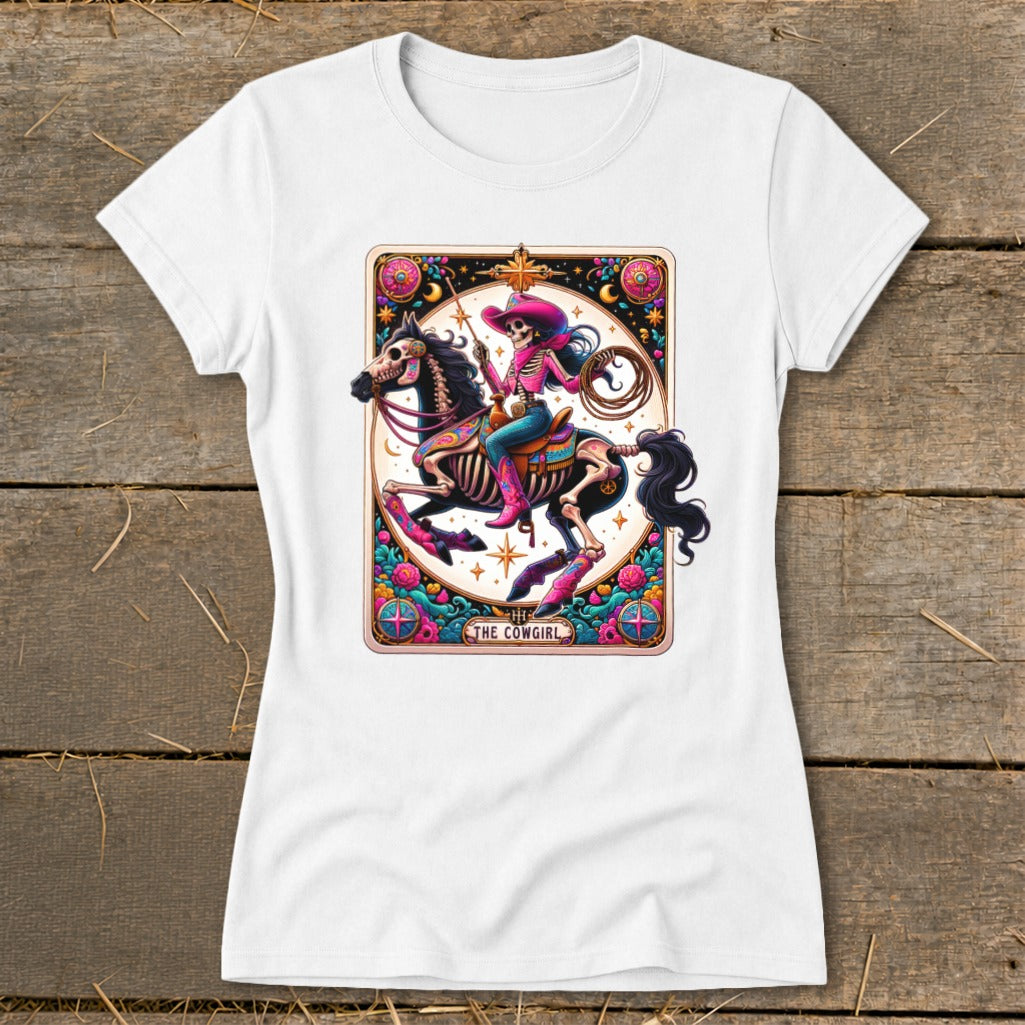 Skeleton cowgirl on horse with lasso, surrounded by floral border and text "The Cowgirl".