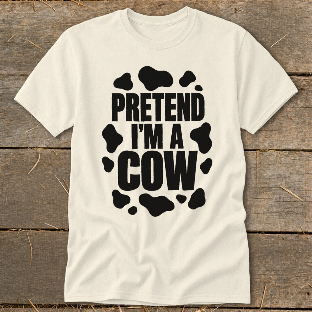 Cream t-shirt with "PRETEND I'M A COW" text in black, surrounded by cow spots.