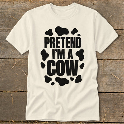 Cream t-shirt with "PRETEND I'M A COW" text in black, surrounded by cow spots.
