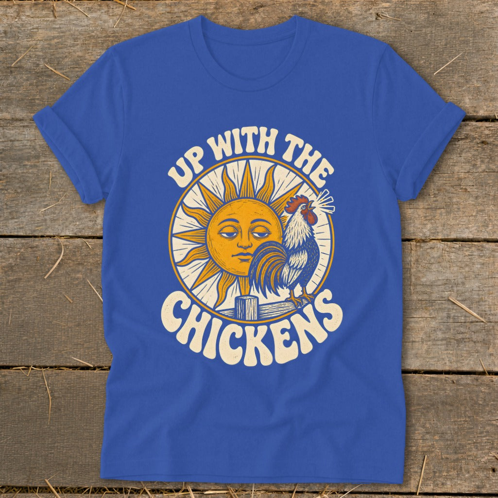 Blue t-shirt featuring a retro graphic of a sun, crowing rooster, and text reading Up With The Chickens.