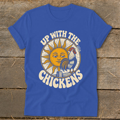 Blue t-shirt featuring a retro graphic of a sun, crowing rooster, and text reading Up With The Chickens.
