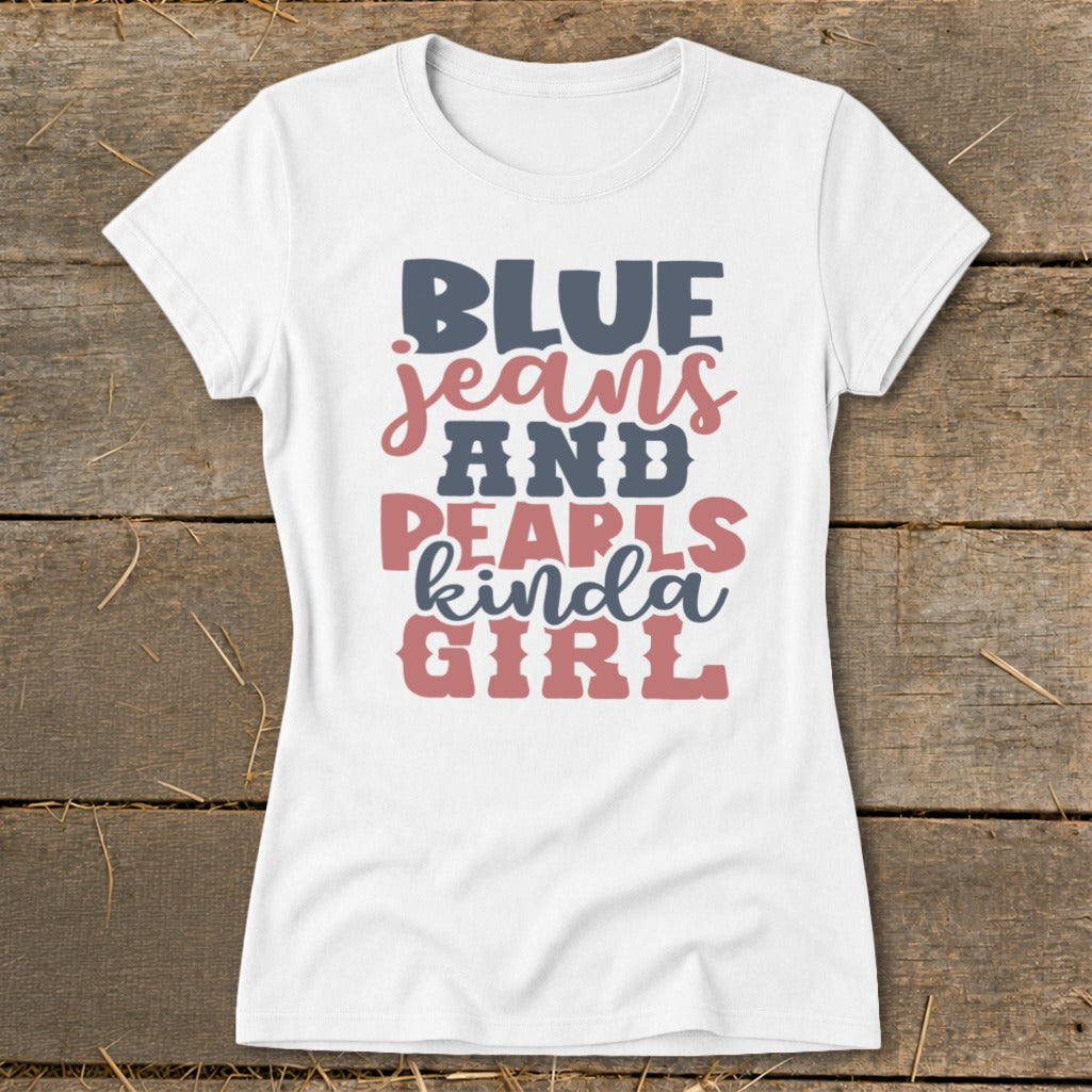 White t-shirt with "BLUE jeans AND PEARLS kinda GIRL" graphic in blue and pink.