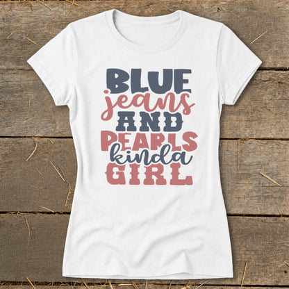 White t-shirt with "BLUE jeans AND PEARLS kinda GIRL" graphic in blue and pink.