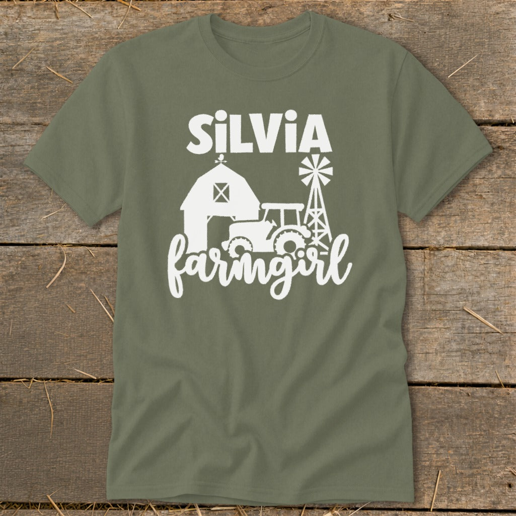 Green t-shirt with white text "Silvia farmgirl" and barn, tractor, windmill graphics.