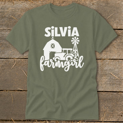 Green t-shirt with white text "Silvia farmgirl" and barn, tractor, windmill graphics.