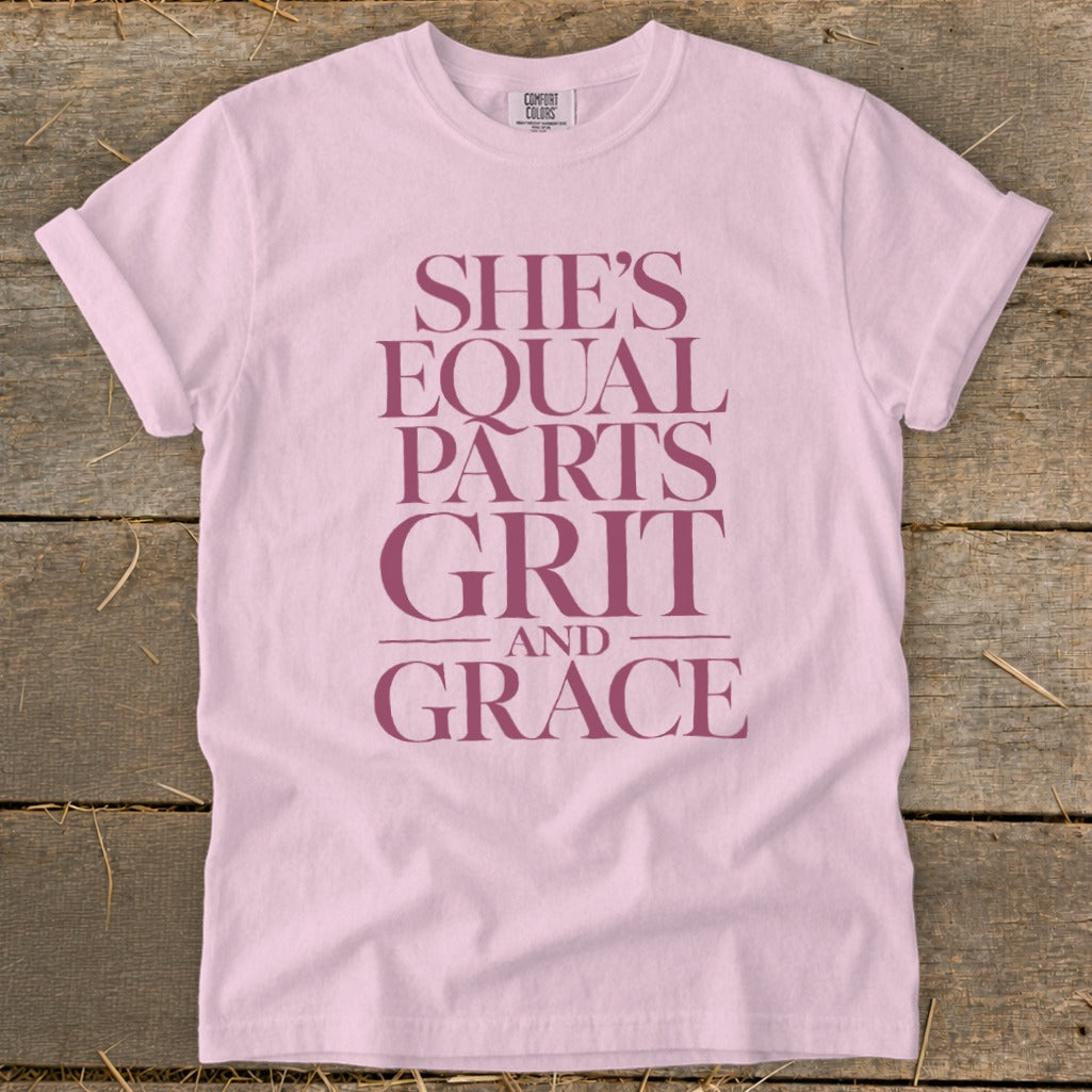 Pink t-shirt with "SHE'S EQUAL PARTS GRIT AND GRACE" text.