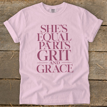 Pink t-shirt with "SHE'S EQUAL PARTS GRIT AND GRACE" text.