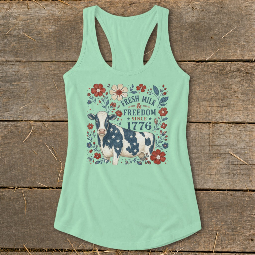 Cow with American flag pattern on a mint green tank top with "Fresh Milk & Freedom Since 1776" text.