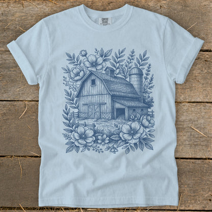 Light blue t-shirt with blue sketch of barn, silo, and flowers.