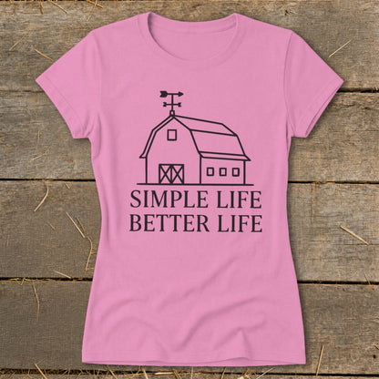 Pink t-shirt with barn graphic and text "SIMPLE LIFE BETTER LIFE".