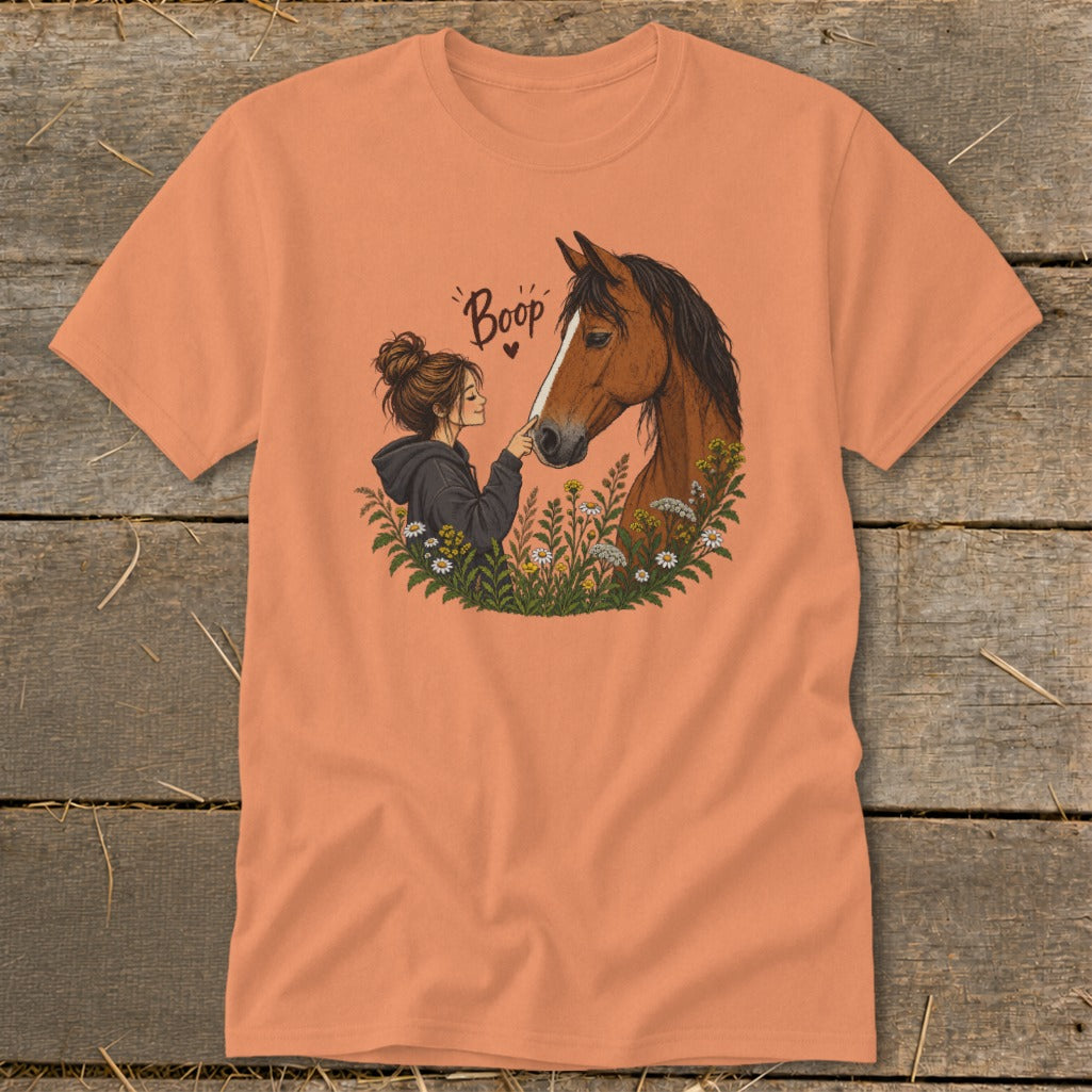 Girl booping horse nose with text "Boop" and a heart on an orange t-shirt.