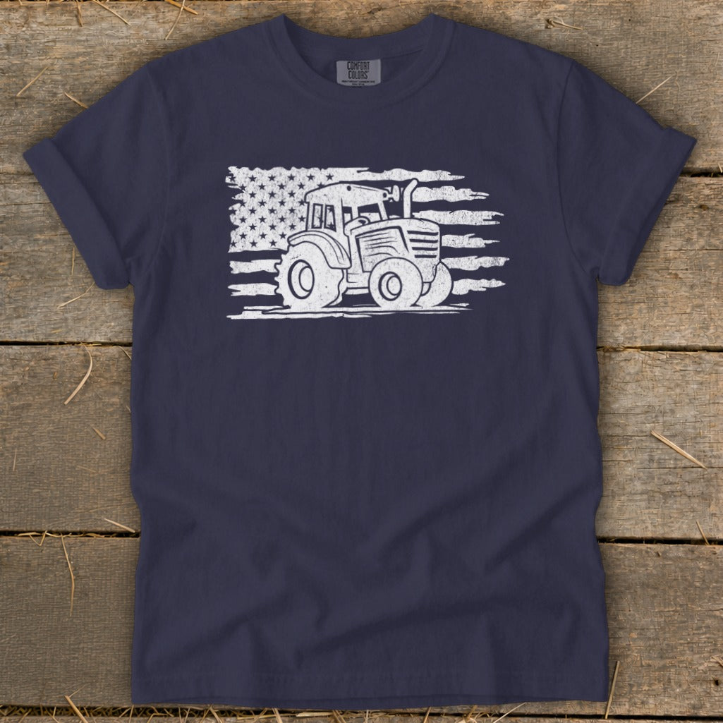 Navy t-shirt with white distressed tractor and American flag graphic.
