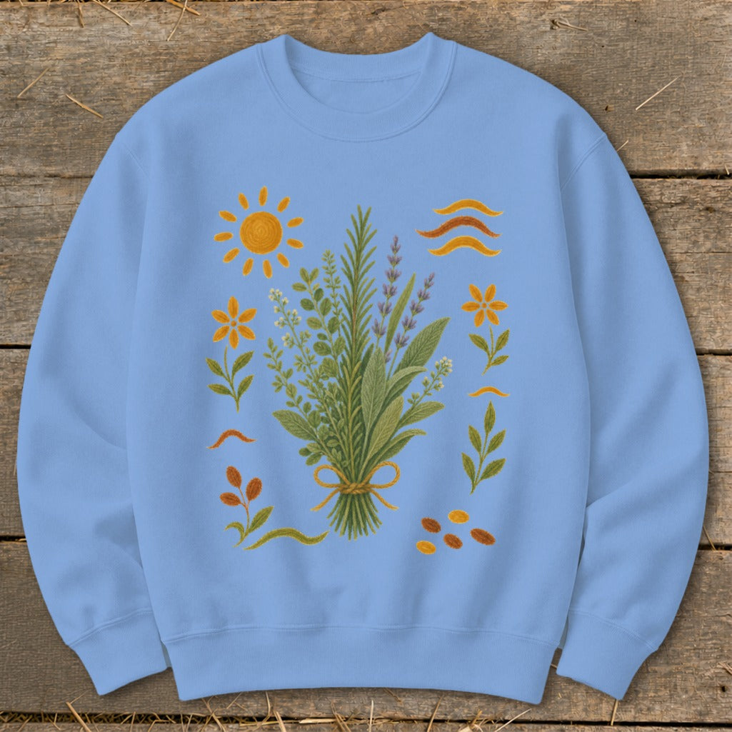 Light blue sweatshirt with an embroidered bouquet of herbs, flowers, sun, and wavy lines.