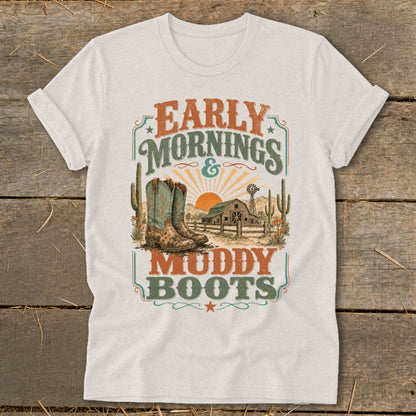 White t-shirt with "Early Mornings & Muddy Boots" graphic featuring cowboy boots, barn, and desert scene.