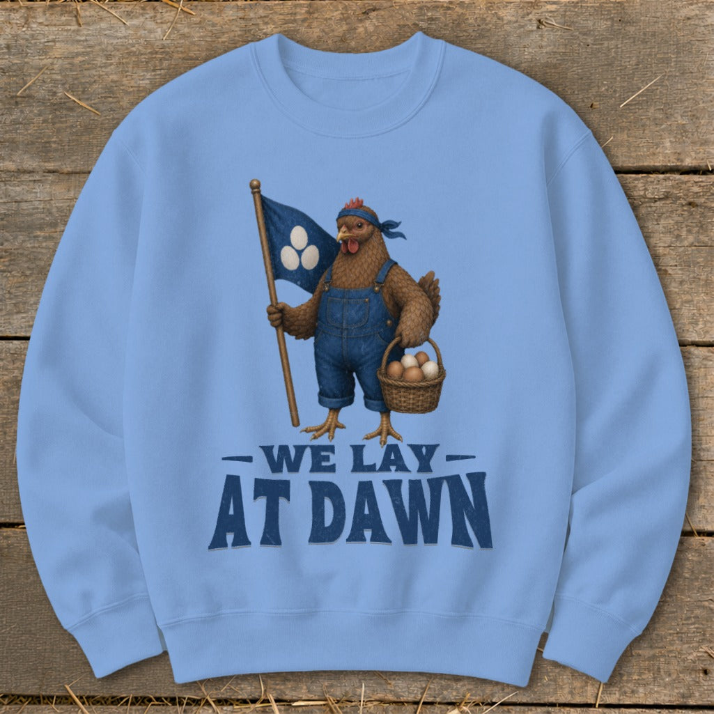 Light blue sweatshirt with chicken graphic and "We Lay At Dawn" text.