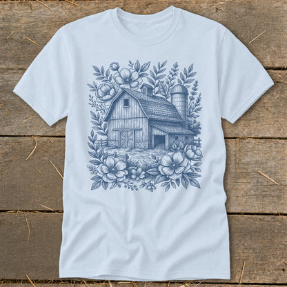 Light blue t-shirt with a blue sketch of a barn and flowers design.