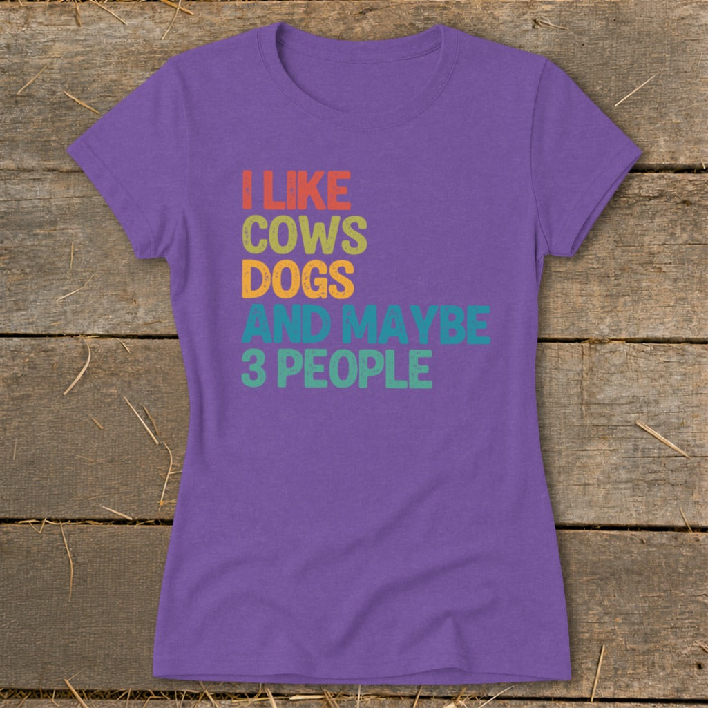 Purple t-shirt with text "I LIKE COWS DOGS AND MAYBE 3 PEOPLE".