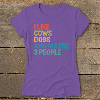 Purple t-shirt with text "I LIKE COWS DOGS AND MAYBE 3 PEOPLE".