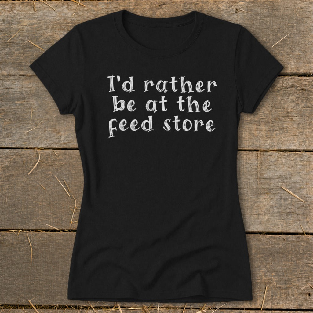 Black t-shirt with white text "I'd rather be at the feed store".