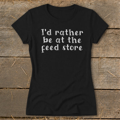 Black t-shirt with white text "I'd rather be at the feed store".