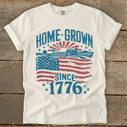 White t-shirt with "HOME GROWN SINCE 1776" and American flag farm scene.