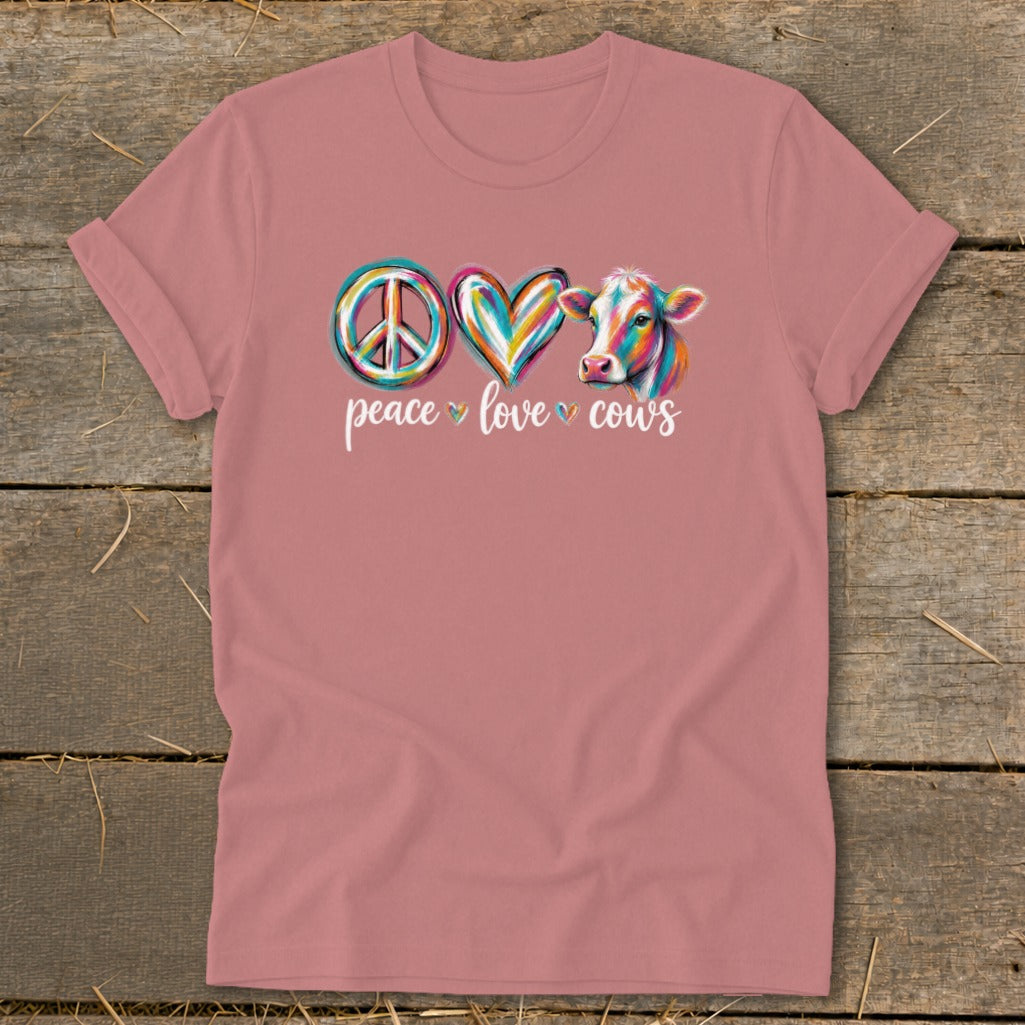 Pink t-shirt with "peace love cows" text and colorful peace sign, heart, and cow graphic.