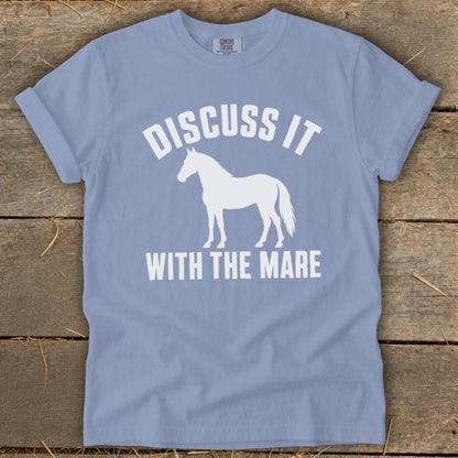 Light blue t-shirt with white text "DISCUSS IT" above a horse silhouette and "WITH THE MARE" below.