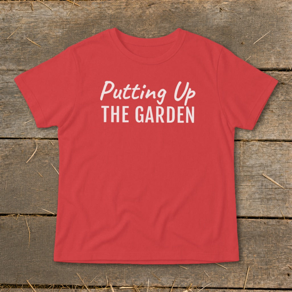 Red t-shirt with white text that reads "Putting Up THE GARDEN".