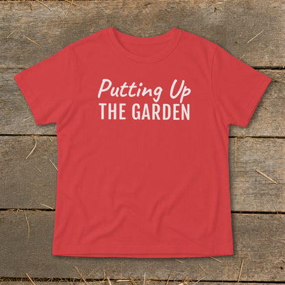 Red t-shirt with white text that reads "Putting Up THE GARDEN".