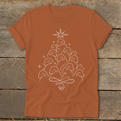 Orange t-shirt with a white line drawing of sheep forming a Christmas tree.