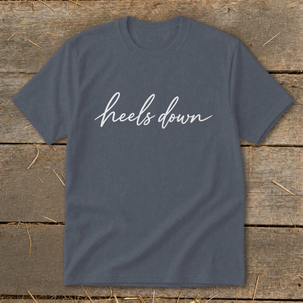 Grey t-shirt with white cursive text "heels down" centered on the chest.