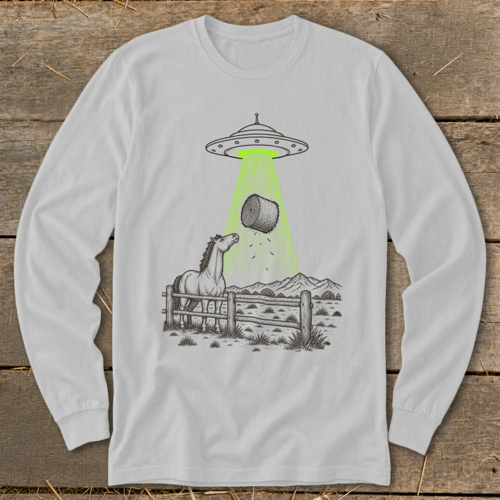Horse looking up at hay bale being abducted by a UFO in a rural landscape.