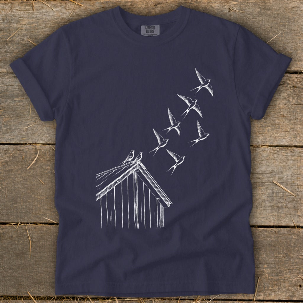 Dark blue t-shirt featuring a white line drawing of birds flying from a rooftop.