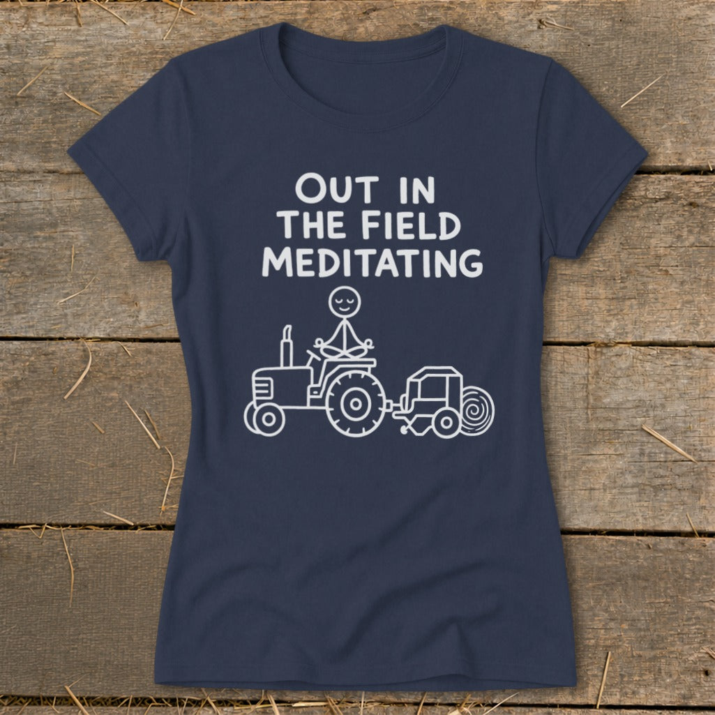 Dark navy t-shirt with white text and cartoon of person meditating on a tractor.